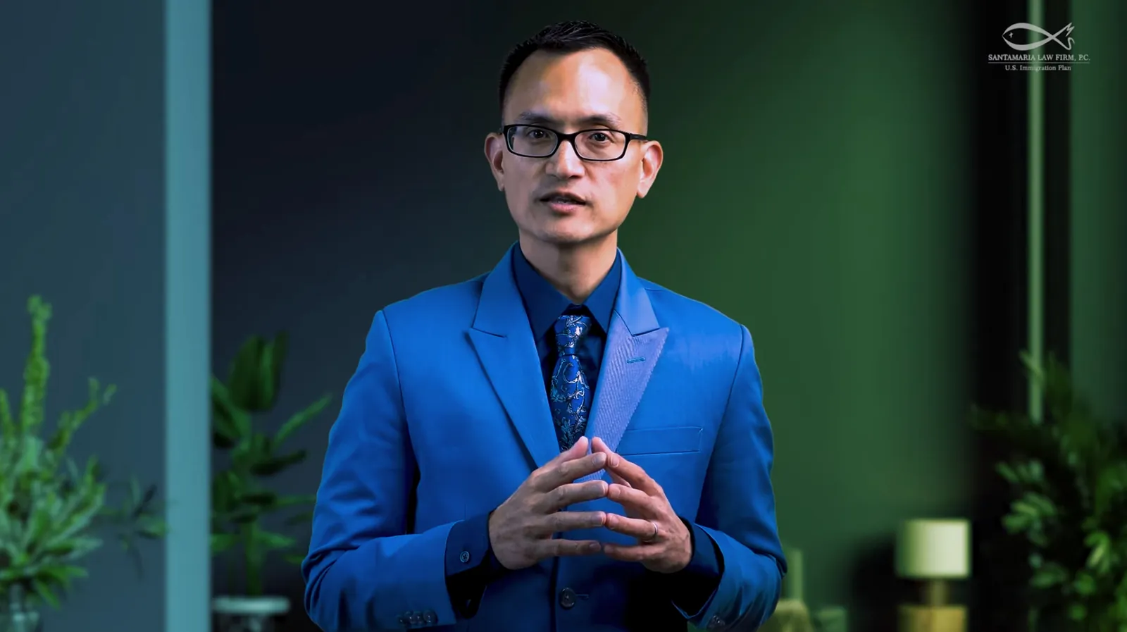 The same frame of the attorney before and after the green-screen key: raw studio backdrop, then the branded office set graded to the firm’s palette
